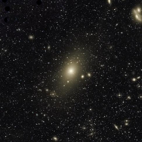 Central Region of the Virgo Cluster. This image is dominated by the giant elliptical galaxy M87 at center. Hundreds of smaller, fainter galaxies seem to swarm around M87.