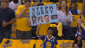 Gif of a Golden State Warriors fan holding a sign and swaying back and forth to cheer on basketball player Steph Curry.