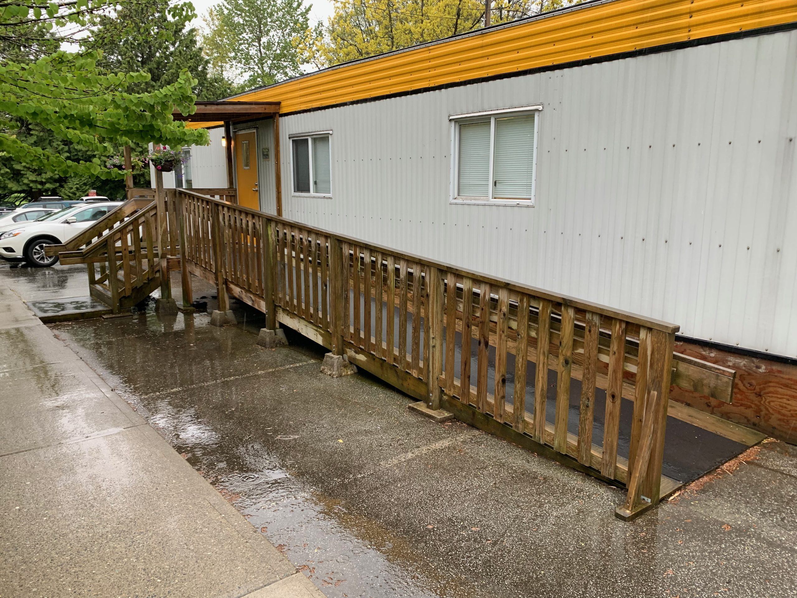 Wooden ramp beside a temporary building on a raining day