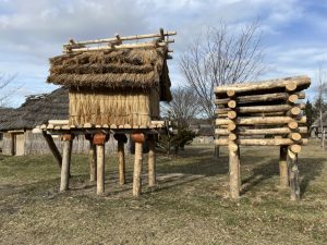 traditional ainu storehouse on stilts and bear cage made of logs