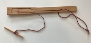 bamboo mouth harp with a string on left for pulling and a looped string on right for holding