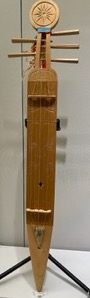 long narrow 5-stringed wooden musical instrument