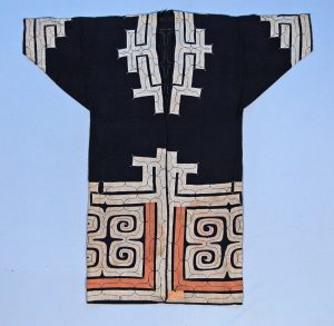 blue cloak with white and orange embroidered applique around hems and collar