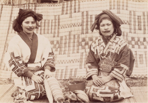 Two Ainu Women surrounded by weaving