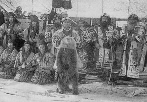 Ainu in ceremonial dress with bear cub
