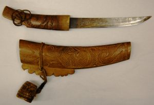 metal knife and carved wooden cover
