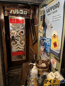 Restaurant entrance with Ainu and beer posters