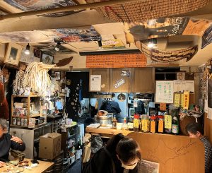 interior of small restaurant decorated with Ainu artifacts
