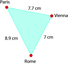 The figure is a triangle formed by Paris, Vienna, and Rome. The distance between Paris and Vienna is 7.7 centimeters. The distance between Vienna and Rome is 7 centimeters. The distance between Rome and Paris is 8.9 centimeters.