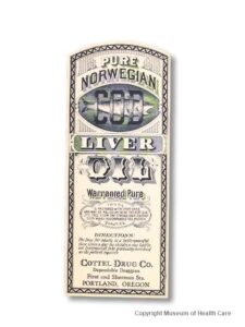 Thin paper label for Pure Norwegian Cod Liver Oil from the Cottel Drug Co.; blue ink; top third has a facsimile of a fish they hoped looked like cod, with the word "COD" over top of it; adhesive still on back; rounded top.