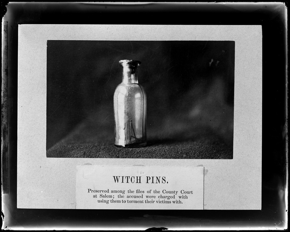 Photograph of "witch pins" in a jar.