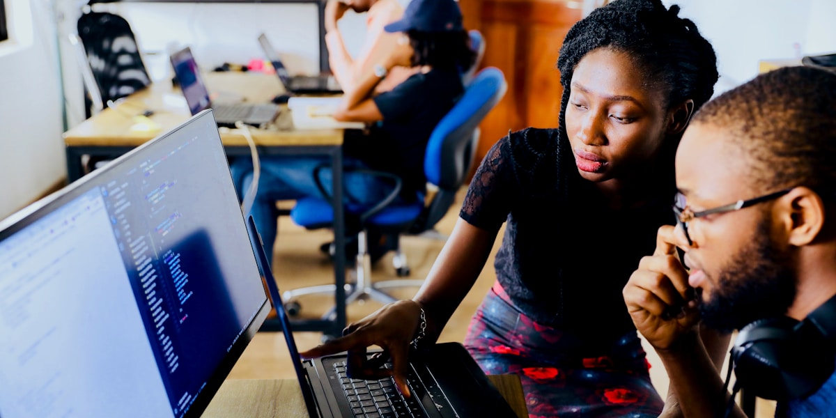 Person using tablet and digital tools on a work desk representing technology for trades businesses
