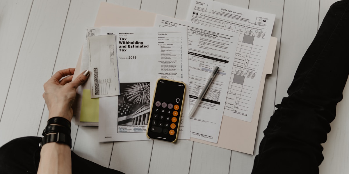 Calculator and tax documents on a desk representing GST planning for small business