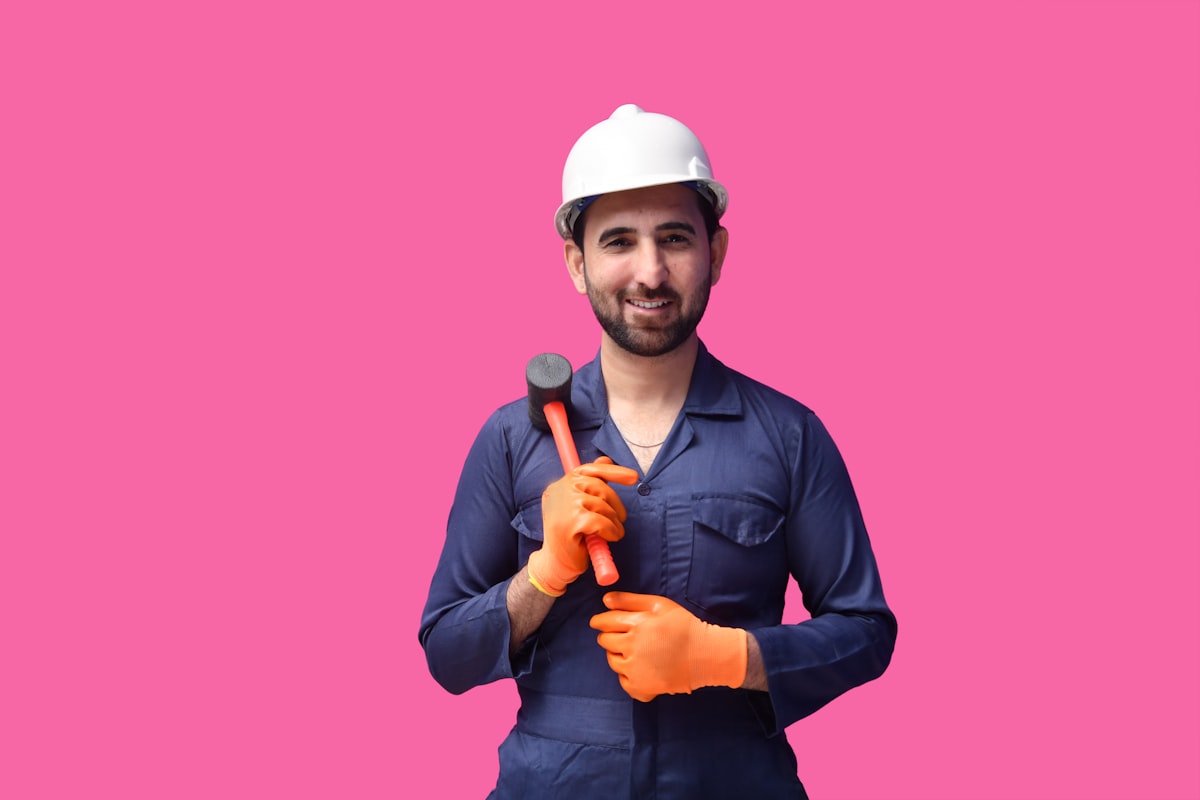 Worker wearing safety hard hat, representing licensing, insurance and risk management in the trades