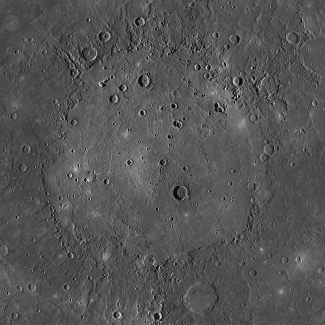 Photograph of the Caloris Basin on Mercury. The circular, flat plain of Caloris Basin is surrounded by cratered highlands and rough terrain. A few impact craters are scattered over the smooth surface of the basin.
