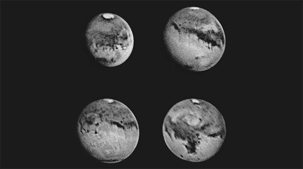 The entire surface of Mars in four photographs. The white polar ice cap is visible at the top of each image along with several cloud formations and dark surface markings.