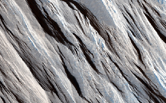 Maritan wind erosion. The long, straight wind-blown ridges cross this image from the upper left to the lower right.