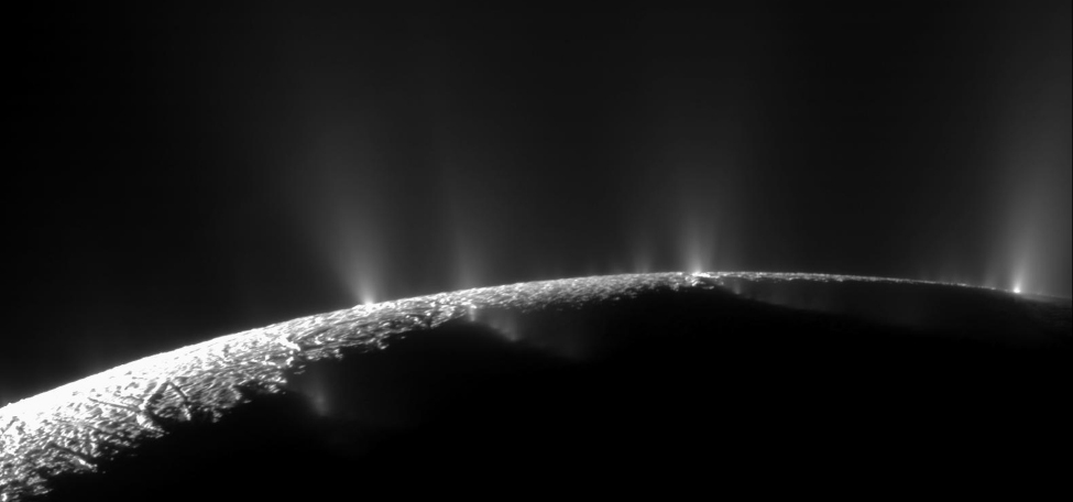 An image of the surface of Enceladus, from which a number of water geysers stream.