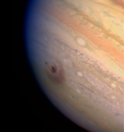Impact Dust Cloud on Jupiter. The bulls-eye like impact site is visible to the left of center in this HST image of Jupiter.