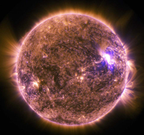An image of a solar flare, a bright region to the right of the sun.