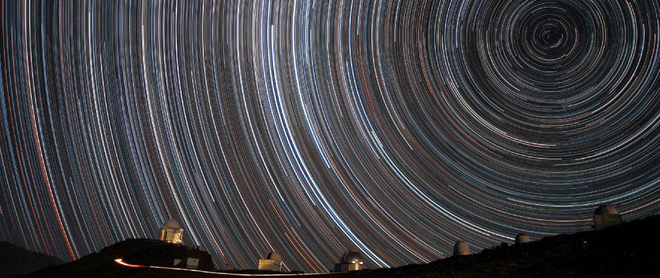 Time exposure photograph of the night sky, showing stars as semi-circular streaks of light, rather than points, due to the rotation of the Earth.