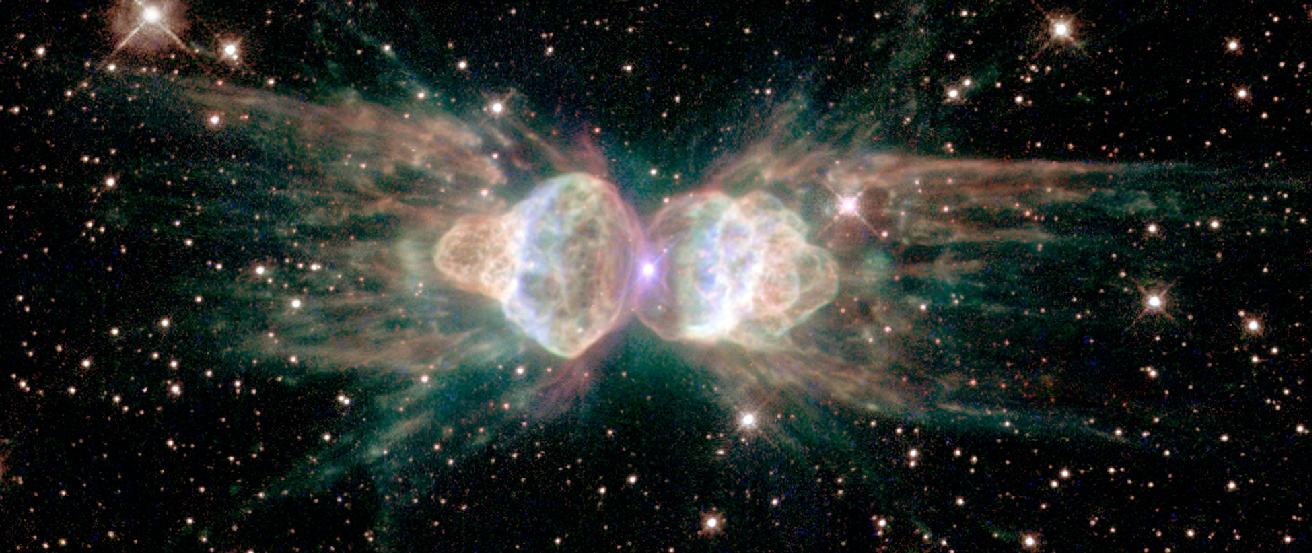 False-color Image of the Ant Nebula. This “planetary nebula” consists of a central star (located at the center of this image), bracketed on the left and right by two lobes of gaseous material. The image is colored such that red corresponds to sulfur emission, green to nitrogen, blue to hydrogen, and blue/violet to oxygen.