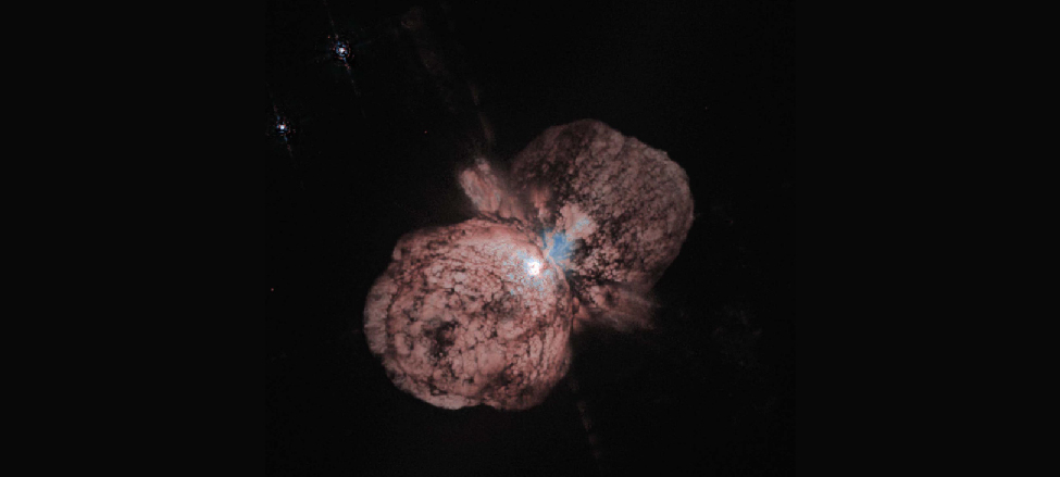 The Eta Carinae Ejection Nebula. At the center of this H S T image is the slightly obscured star Eta Carinae which is surrounded by two giant lobes and an equatorial disk of material.