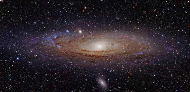 The Andromeda Galaxy. The compact nucleus of our nearest large galactic neighbor is seen at the center of this visible light image, with the blue spiral arms and thick dust lanes circling around the outer parts of the galaxy.