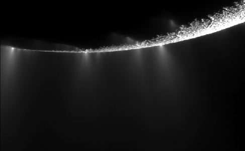Saturn’s Moon Enceladus. Four plumes of ice and gas are arrayed across the backlit edge of Enceladus.
