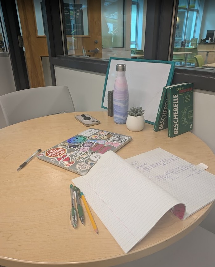 Laptop sitting on top of wooden table