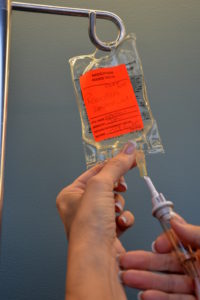 Inserting spike into secondary IV bag