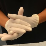 Apply sterile glove to each hand or apply non-sterile glove to non-dominant hand and sterile glove to dominant hand