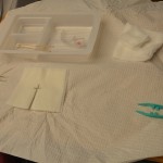 Set up sterile tray and add cleaning solution and supplies
