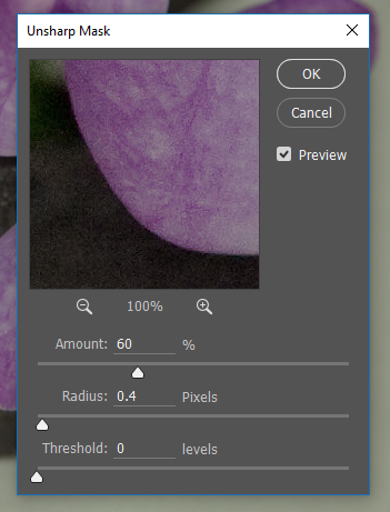 Screencapture of the Photoshop® Unsharp Mask filter controls, consisting of an image preview area with slider controls for Unsharp Amount, Radius, and Threshold.