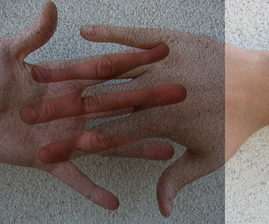 Composite image made from two photographs of hands, one is overlaying the other using the Photoshop® Multiply blend mode.