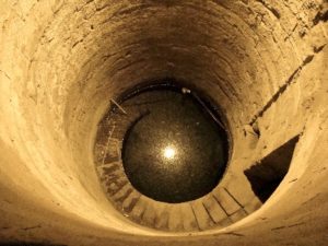 Looking down an empty well hole at Kom Ombo built by the ancient Egyptians