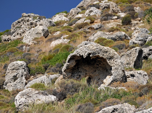 A hillside in Greece showing the breakdown of limestone by chemical and mechanical weathering