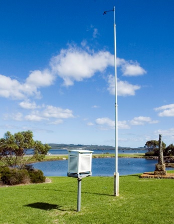 A picture of a stevenson screen and anemometer, which are used to monitor weather conditions
