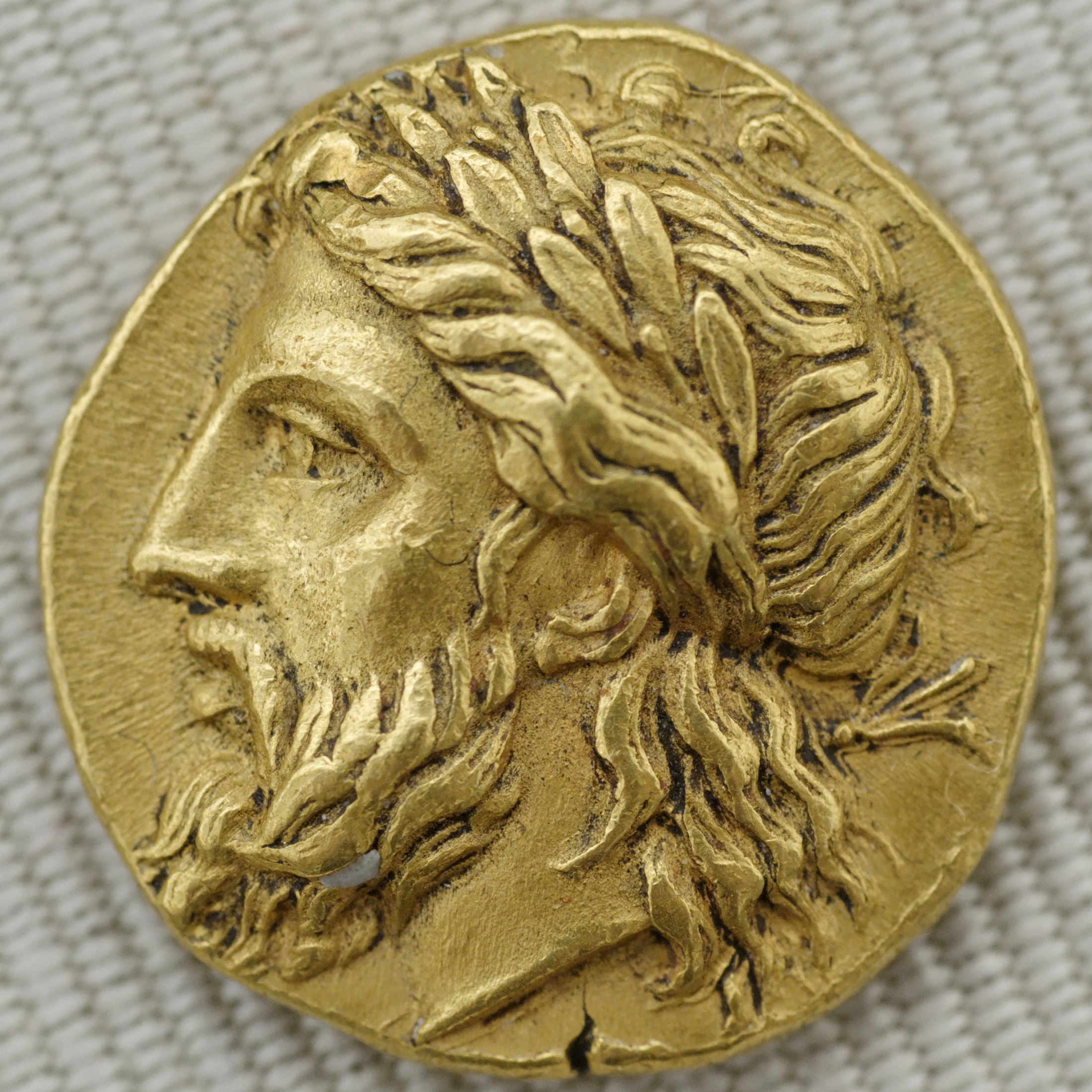 Head of Zeus, bearded and wearing a crown of laurels.