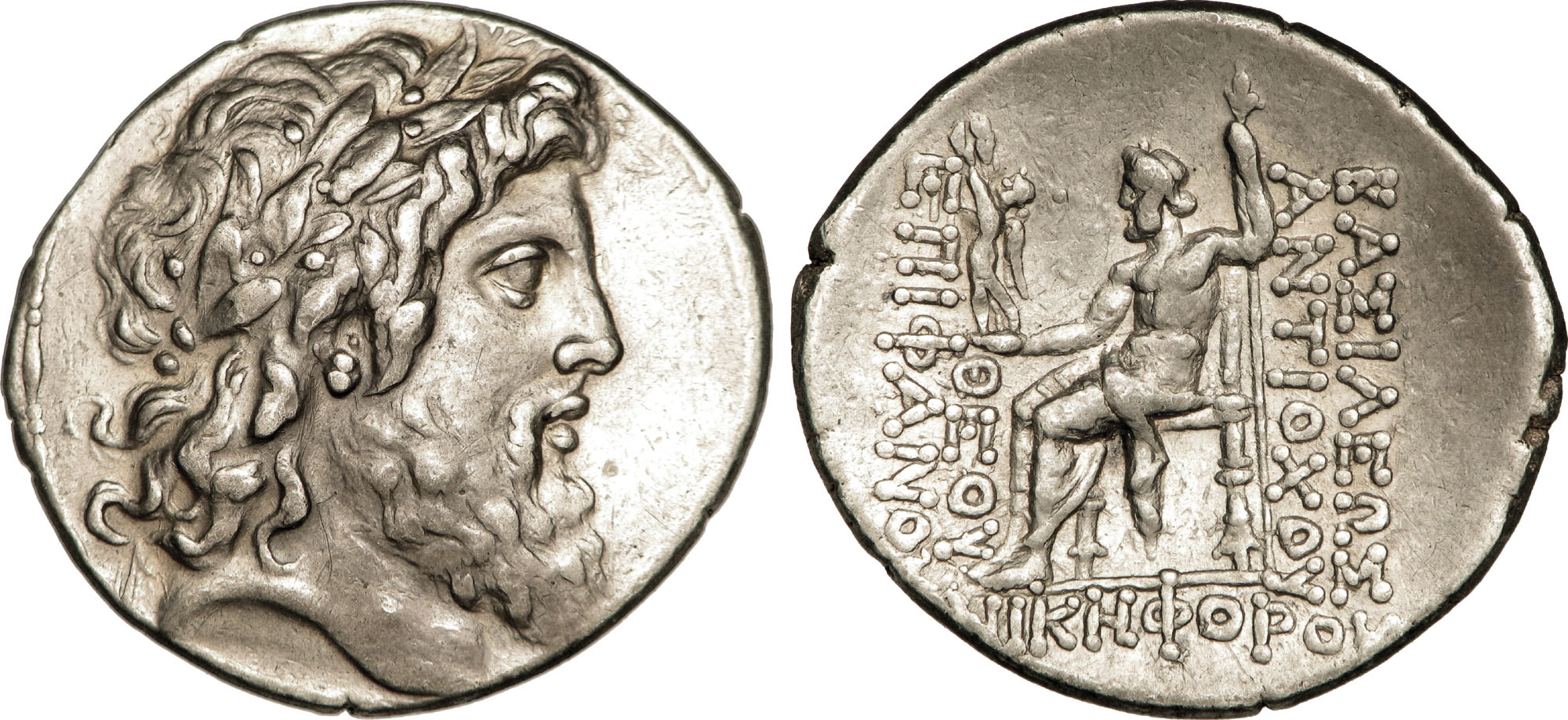 Two sides of a coin. One side shows the head of Zeus, and the other shows Zeus seated holding a statue of Nike.