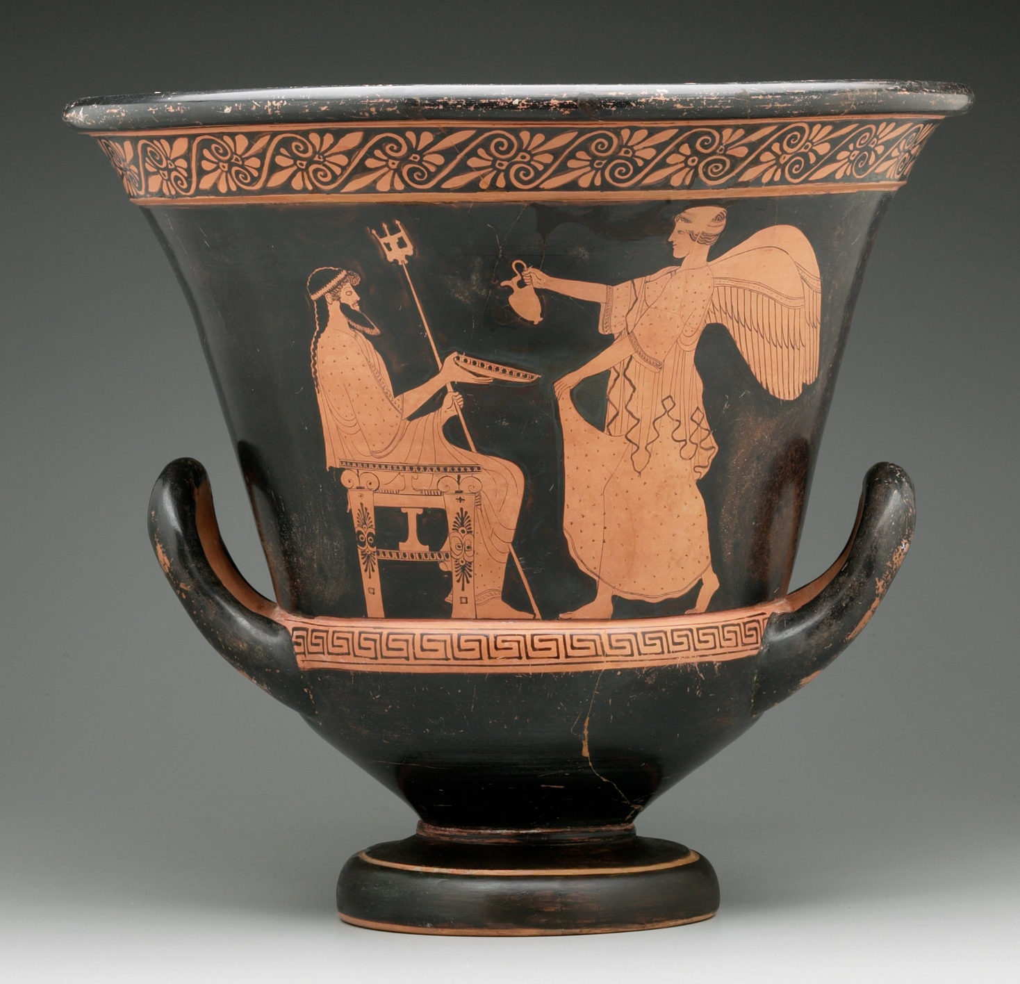 Poseidon seated holding a trident and bowl. The winged goddess Nike waits on him.