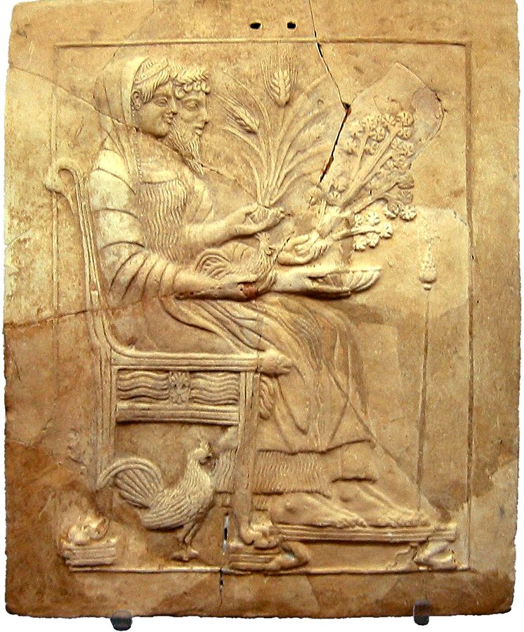 Hades and Persephone seated together. Persephone holds a stalk of grain and a chicken.