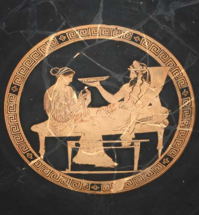 Persephone seated and Hades lounging holding a dish.