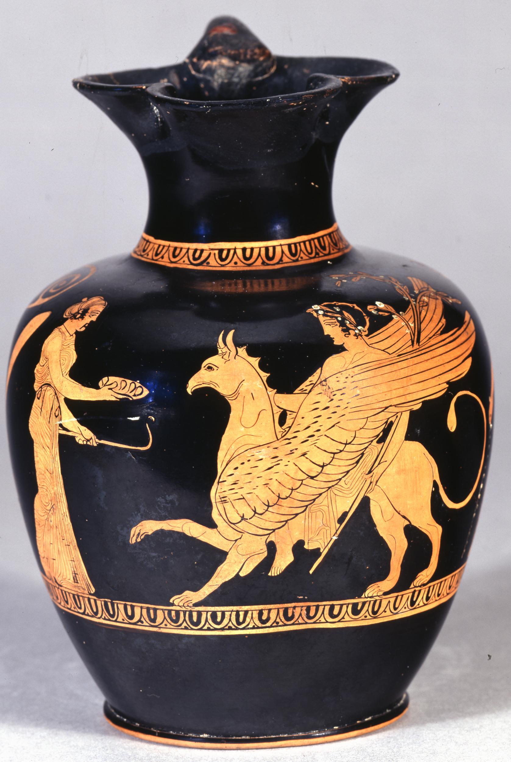 On the right Apollo, wearing laurels, rides a winged griffin. In front of him stands Artemis, richly dressed, holding a phiale out to Apollo.
