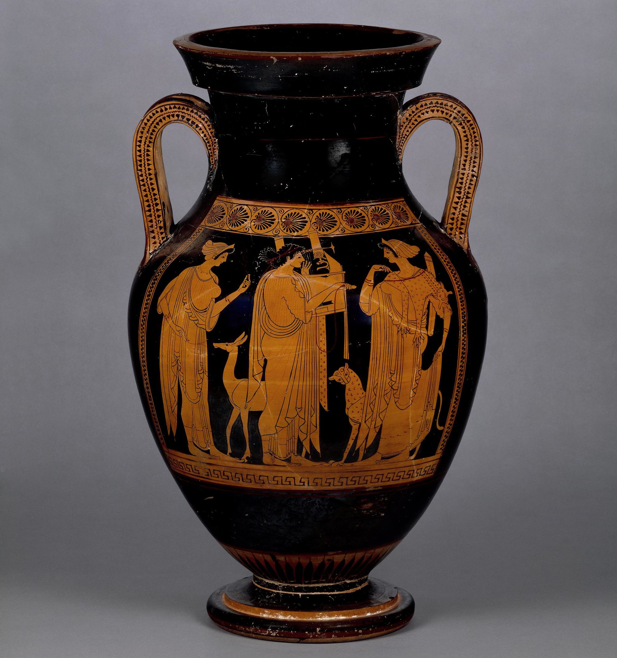 To the left stands Leto holding a flower, dressed in chiton and himation. At her feet is a deer. In the centre stands Apollo, playing a cithara and similarly dressed. On the right stands Artemis with a panther at her feet. She is wearing animal skins and much jewelry.