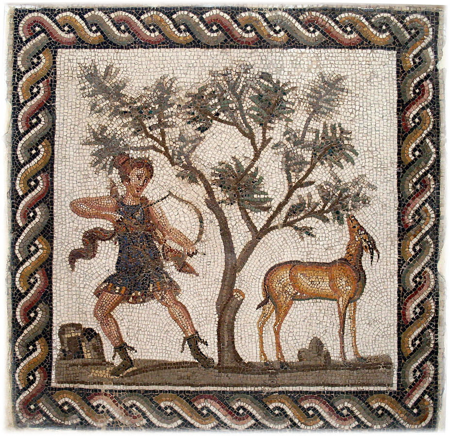 Diana lunges holding a bow with an arrow nocked. She aims at a deer that stands grazing under a tree.