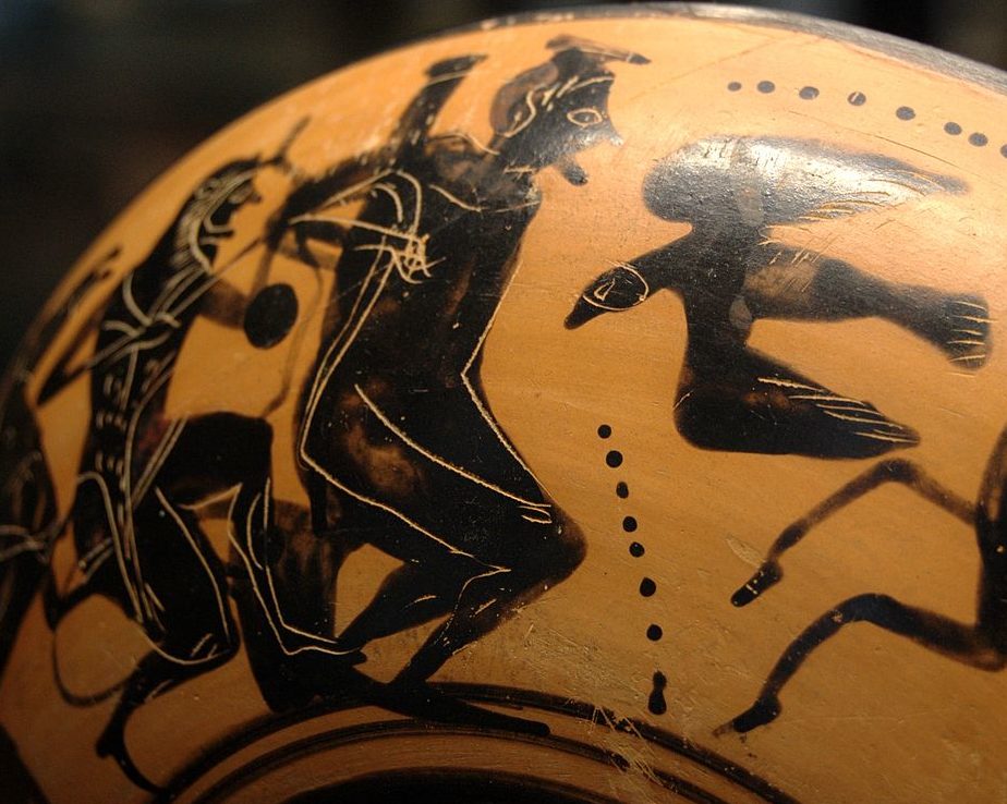 Prometheus crouches tied to a pole. Heracles, dressed in a lion skin, stands behind Prometheus and unties him. The eagle approaches Prometheus from the other side.