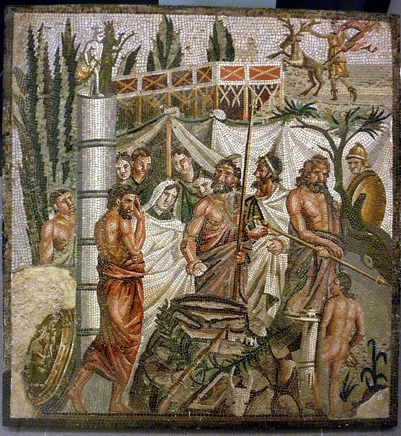 Agamemnon and a veiled Clytemnestra stand holding hands, by a luxurious tent surrounded by attendants. In the background, Artemis runs with a deer.