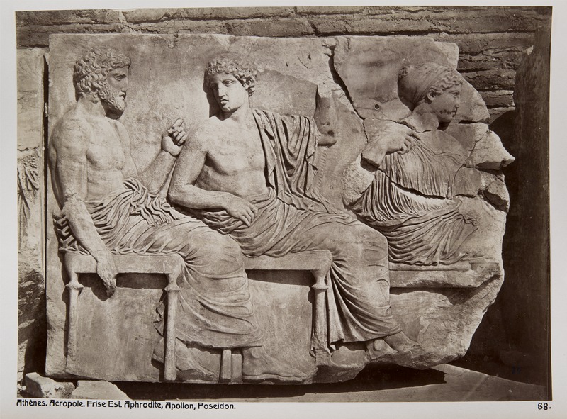 Left to right: Poseidon, Apollo, and Aphrodite seated in procession. Apollo is a beardless youth draped in a himation.