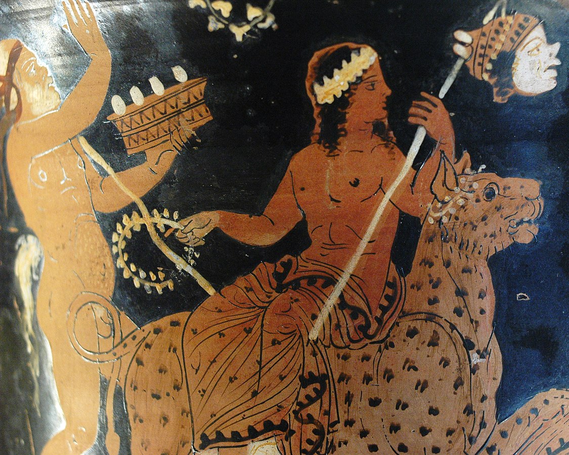 Youthful, long-haired, and crowned Dionysus rides on a panther. He holds a vine in one hand and in the other, a stick with a decapitated head on it. A silenus dances beside him, beating a drum.